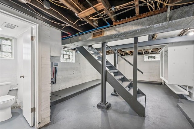 basement featuring stairway and visible vents