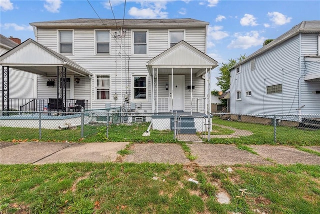 view of front of home with a fenced front yard, a front yard, and a gate