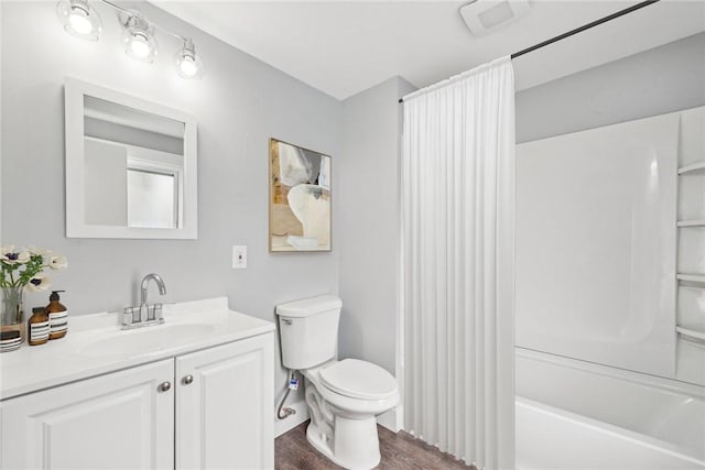bathroom with vanity, shower / bath combination with curtain, toilet, and wood finished floors