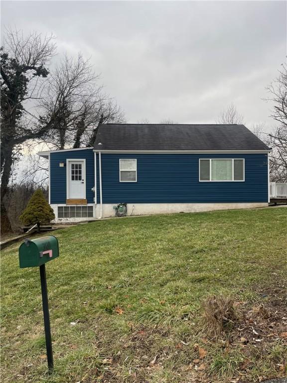 ranch-style house with a front lawn