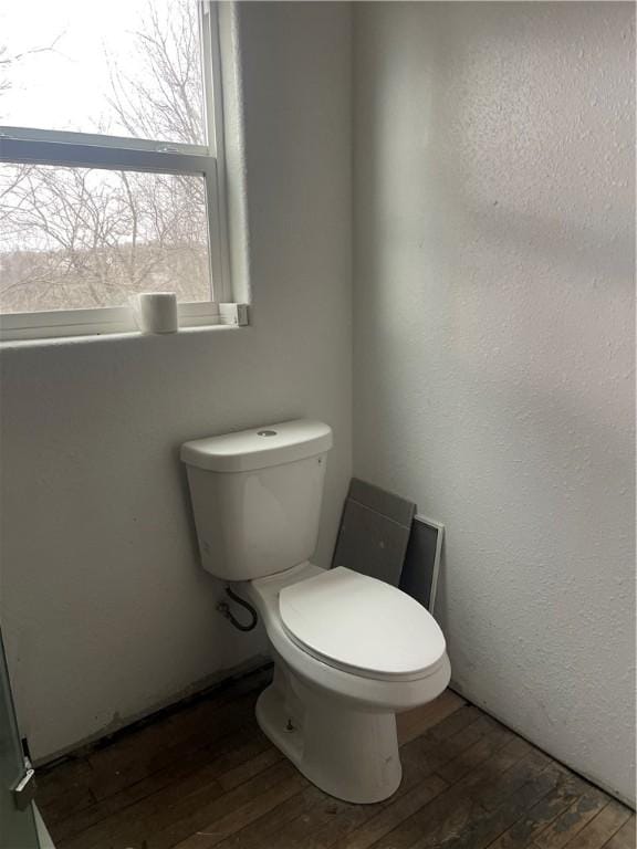 bathroom featuring toilet and wood-type flooring