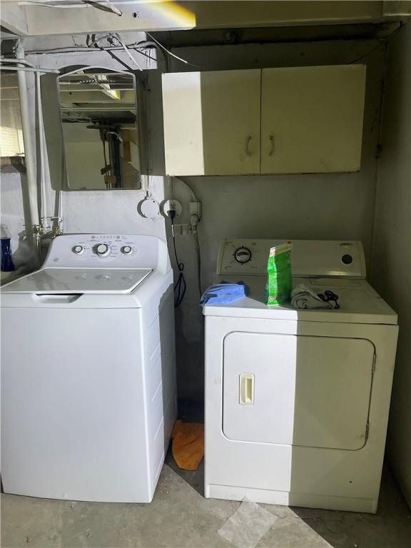 washroom with cabinet space and washer and dryer