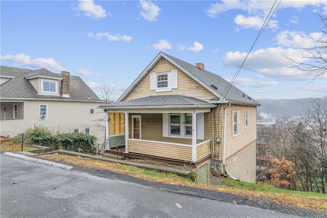 bungalow-style home featuring roof with shingles