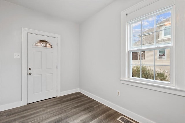 entrance foyer featuring dark wood-style flooring, visible vents, and baseboards