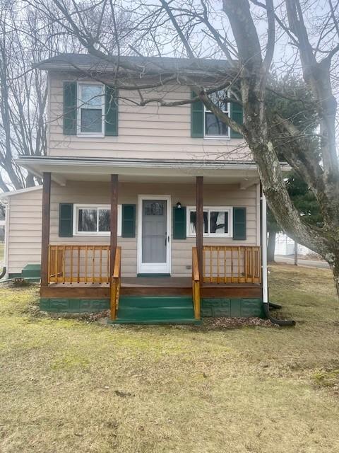 view of front facade with covered porch and a front lawn