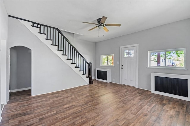 foyer with a healthy amount of sunlight, stairway, and wood finished floors