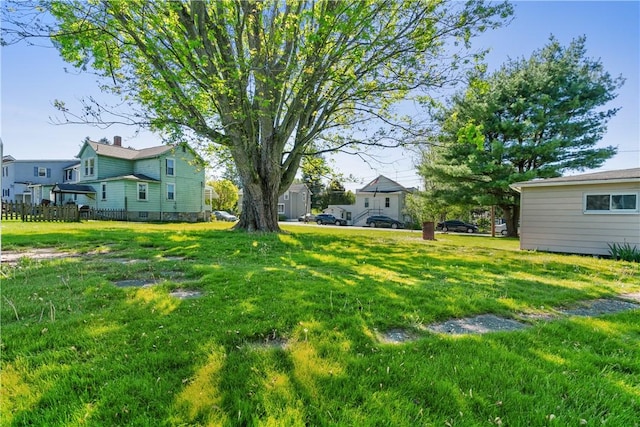 view of yard with a residential view and fence
