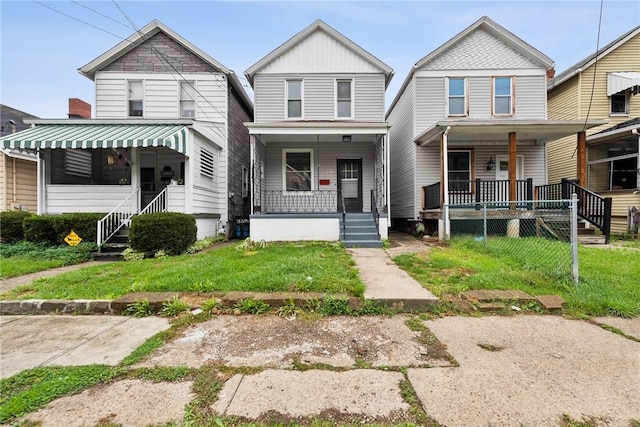 view of front facade with covered porch and a front yard