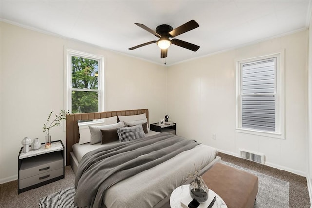 carpeted bedroom with visible vents, crown molding, and baseboards