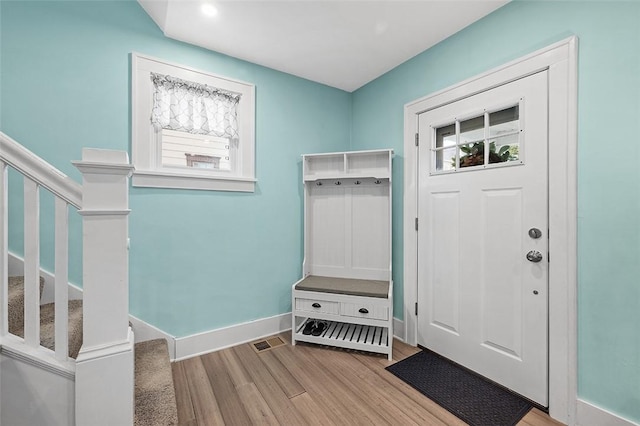 mudroom featuring wood finished floors, a wealth of natural light, and baseboards