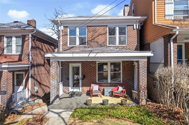 back of property featuring brick siding, a patio area, and fence