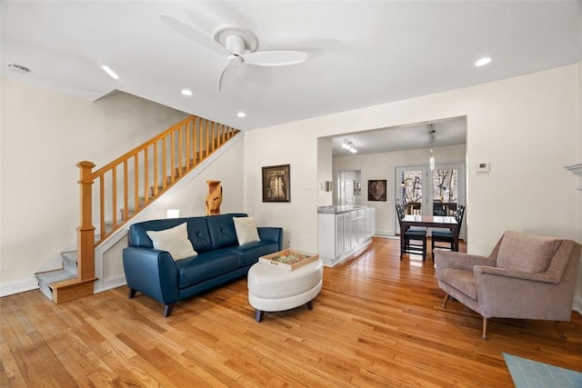 living area with stairs, ceiling fan, light wood finished floors, and recessed lighting