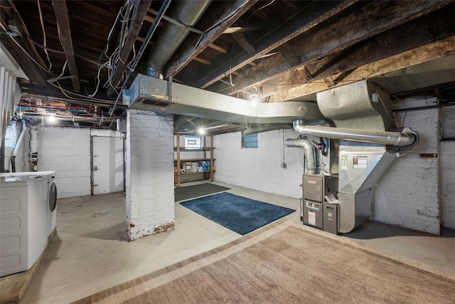 basement with washing machine and dryer and heating unit