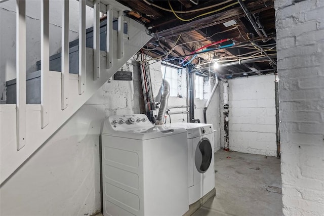 clothes washing area with laundry area and washing machine and clothes dryer