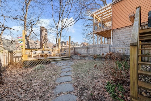 view of yard with a fenced backyard and a wooden deck