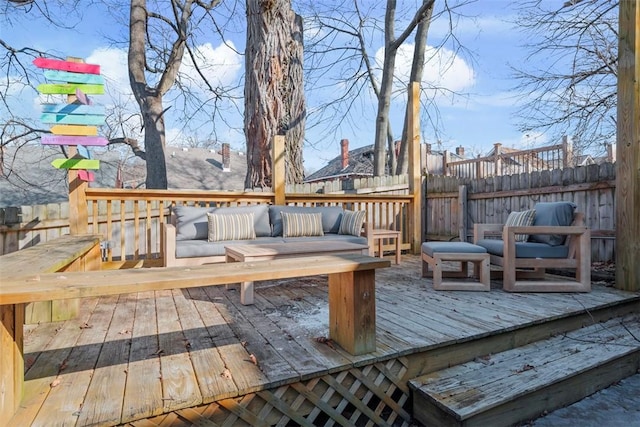 wooden terrace featuring fence and an outdoor living space