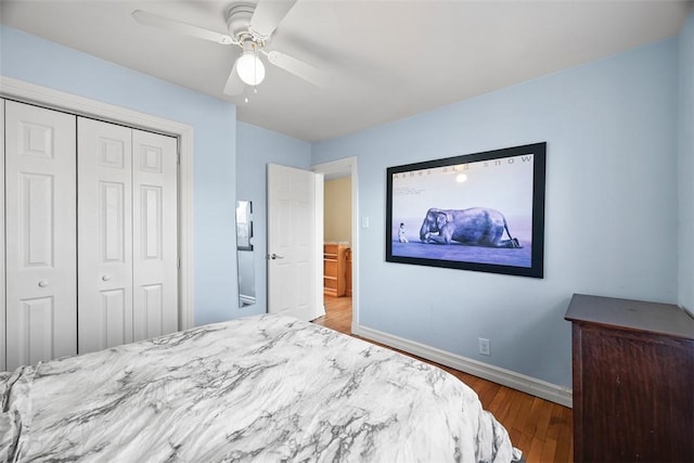 bedroom with ceiling fan, baseboards, a closet, and wood finished floors