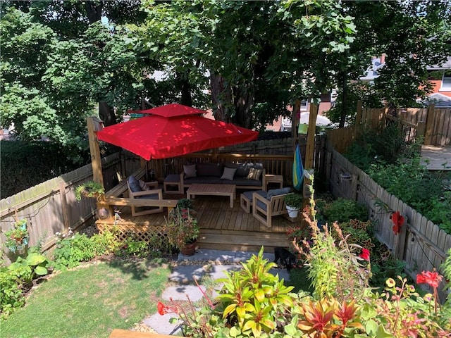 exterior space with a deck, a fenced backyard, and an outdoor living space