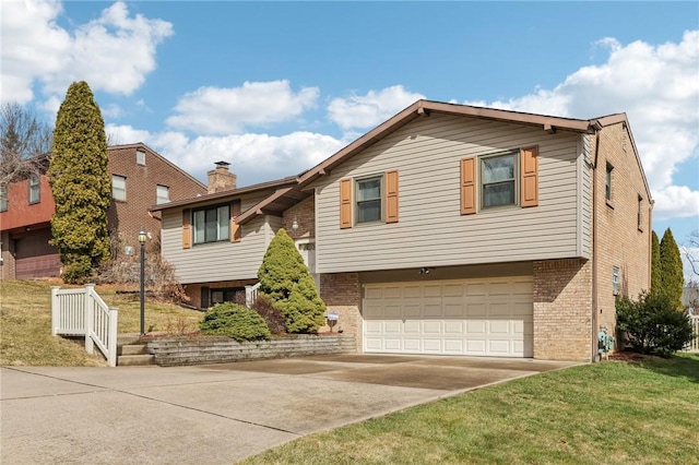 raised ranch with a garage, brick siding, driveway, and a chimney