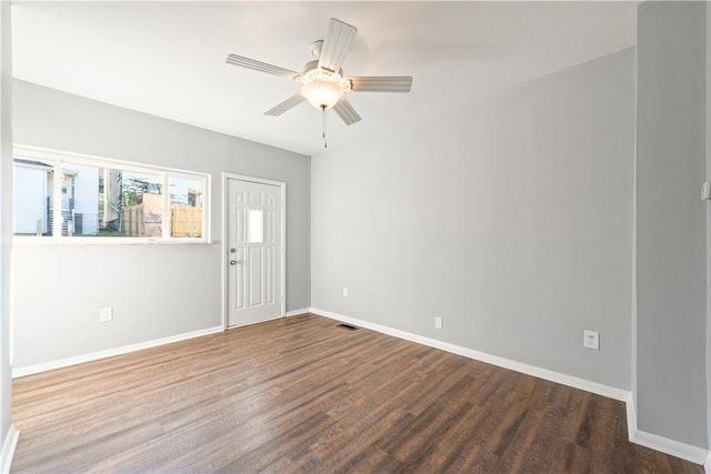 unfurnished room featuring visible vents, a ceiling fan, baseboards, and wood finished floors