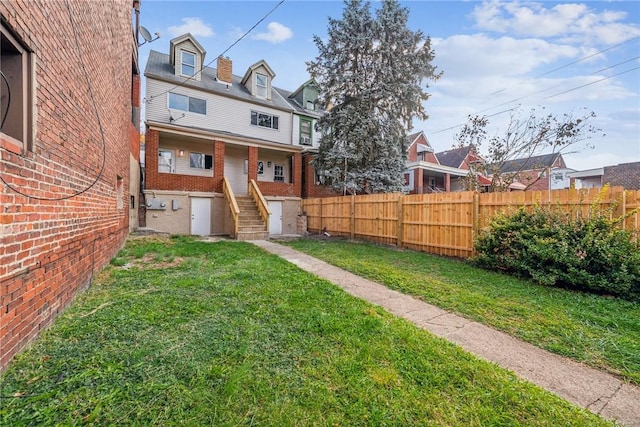 view of yard featuring fence and a residential view