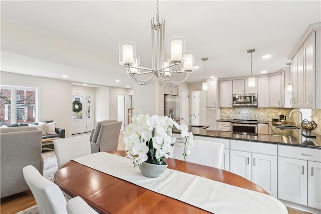 dining area featuring recessed lighting and an inviting chandelier