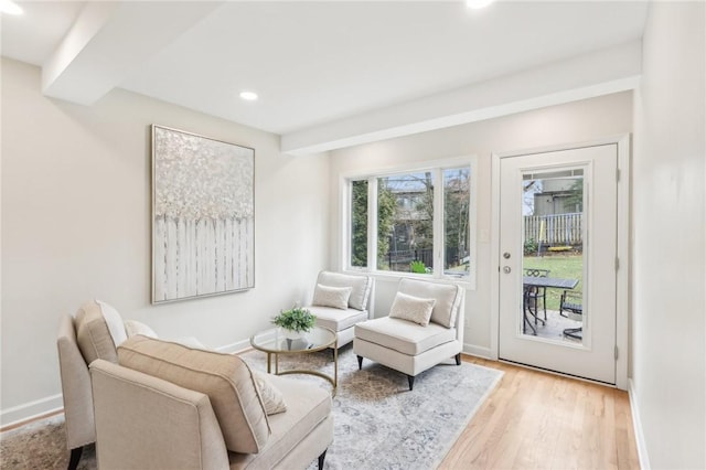 sitting room featuring light wood finished floors, baseboards, and recessed lighting