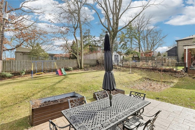 view of yard with outdoor dining space, a patio area, and a fenced backyard