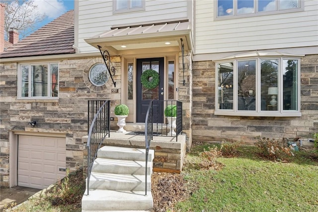 entrance to property featuring a garage and stone siding