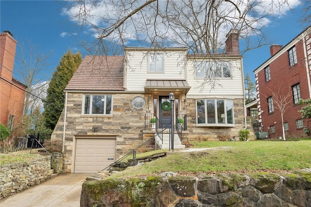 view of front facade with an attached garage, stone siding, concrete driveway, a front lawn, and a chimney