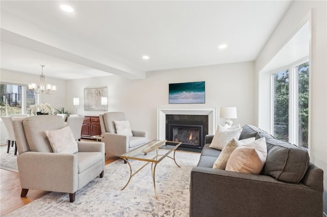 living area with plenty of natural light, light wood-type flooring, a high end fireplace, and recessed lighting