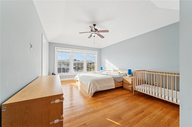 bedroom with light wood-style floors and a ceiling fan