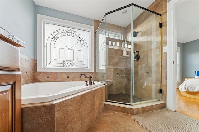 bathroom with a stall shower, connected bathroom, a bath, and tile patterned floors