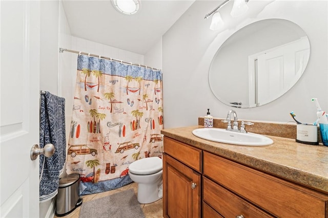 bathroom with tile patterned flooring, a shower with curtain, vanity, and toilet