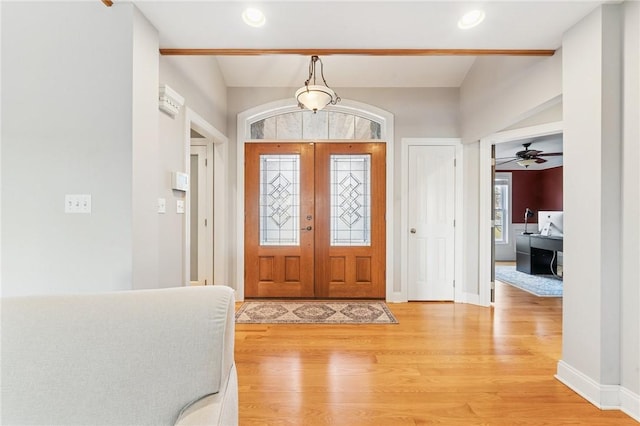 entrance foyer with recessed lighting, french doors, light wood-style flooring, and baseboards