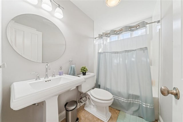 full bathroom featuring shower / bath combo, a sink, toilet, and tile patterned floors