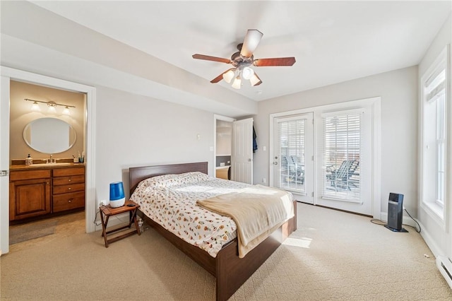 bedroom featuring a baseboard radiator, light carpet, connected bathroom, a sink, and access to outside