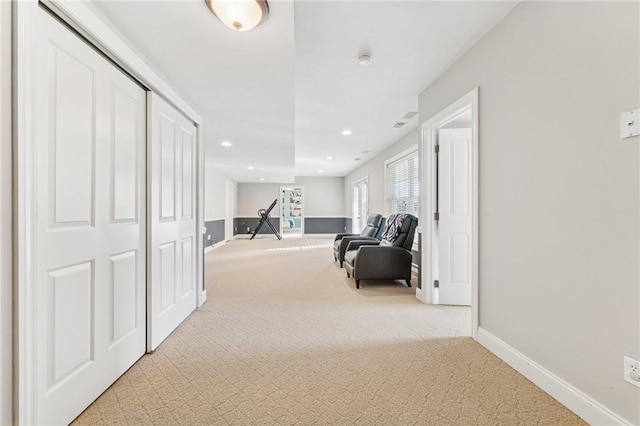 corridor featuring light carpet, recessed lighting, and baseboards