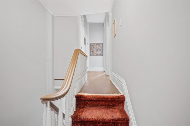 stairway with baseboards and wood finished floors