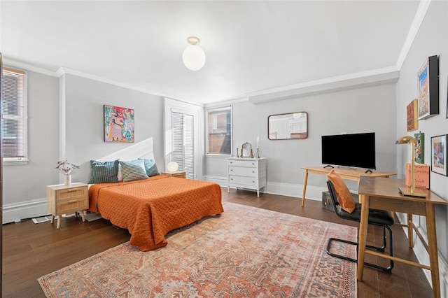 bedroom featuring crown molding, baseboards, and wood finished floors