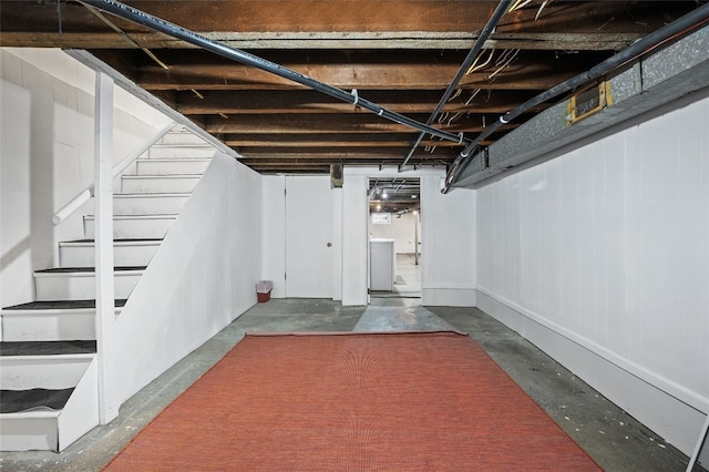 unfinished basement featuring stairway