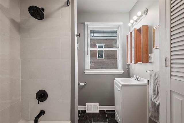 bathroom featuring tub / shower combination, vanity, visible vents, and baseboards