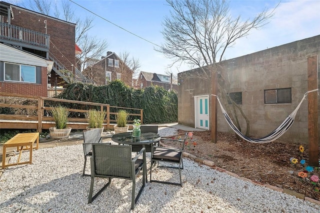 view of patio with outdoor dining area and a wooden deck