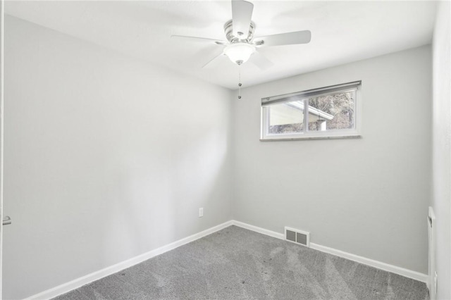 carpeted empty room with ceiling fan, visible vents, and baseboards