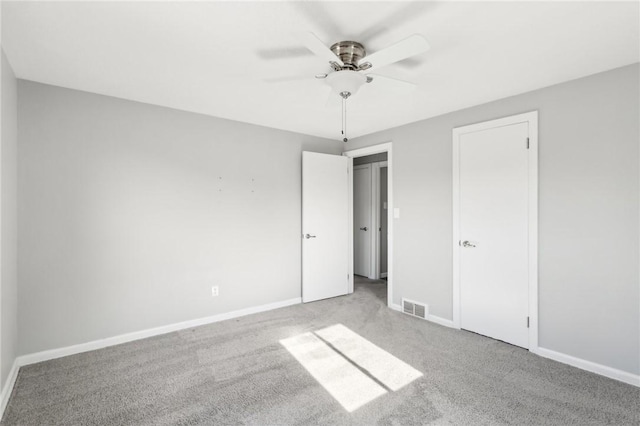 unfurnished bedroom with carpet floors, visible vents, and baseboards