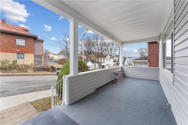 view of patio featuring a porch and a residential view