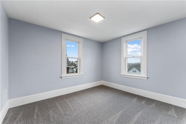 unfurnished room featuring carpet, baseboards, and a healthy amount of sunlight