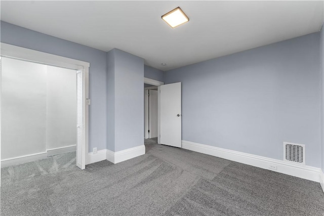 unfurnished bedroom featuring visible vents, carpet floors, and baseboards