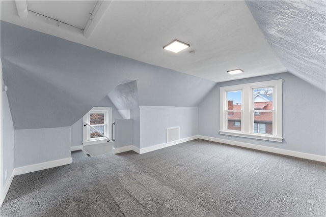 bonus room featuring carpet flooring, lofted ceiling, and baseboards