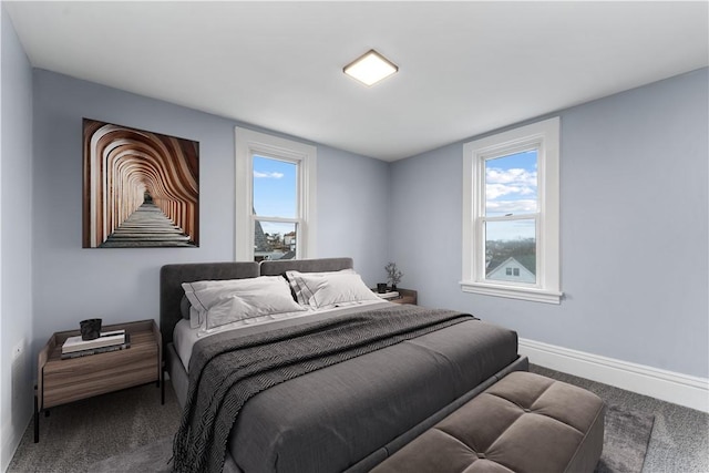 bedroom with carpet flooring and baseboards